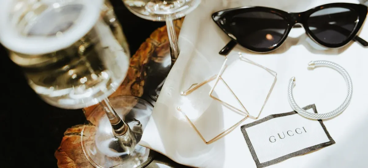 A curated display of 2025 fashion accessories including statement necklaces, smartwatches, eco-friendly bags, and minimalist sunglasses, arranged on a neutral backdrop to highlight their versatility and style."