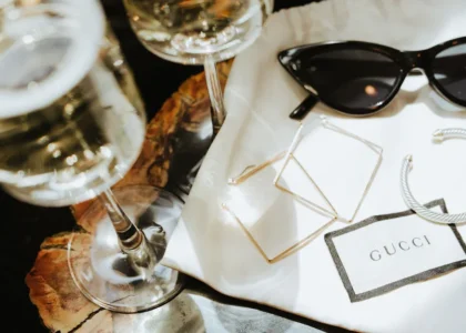 A curated display of 2025 fashion accessories including statement necklaces, smartwatches, eco-friendly bags, and minimalist sunglasses, arranged on a neutral backdrop to highlight their versatility and style."