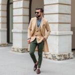 "Stylish young man wearing 2025 men’s fashion trends in a modern Western street style outfit, including oversized blazer, wide-leg trousers, and minimalist sneakers"