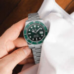 A polished luxury watch with cleaning tools beside it, demonstrating luxury watch care resources in use.