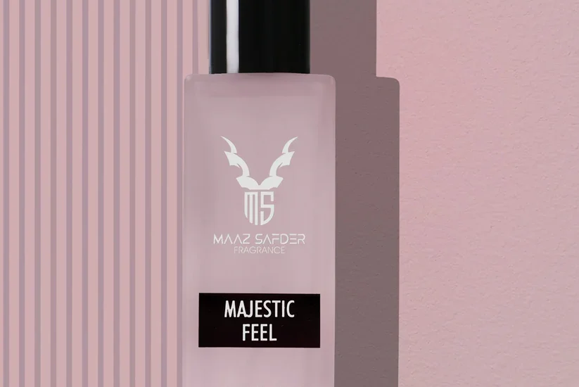 Elegant woman holding Majestic Feel for Women 30ml by Maaz Safder – luxury perfume with floral and musky notes
