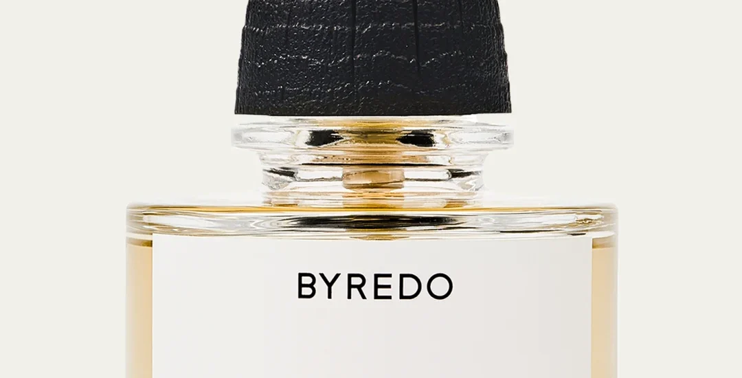 Byredo Bal d’Afrique Absolu de Parfum 1.7 oz. bottle on a neutral-toned fabric background with soft lighting.