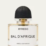 Byredo Bal d’Afrique Absolu de Parfum 1.7 oz. bottle on a neutral-toned fabric background with soft lighting.