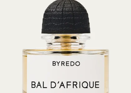 Byredo Bal d’Afrique Absolu de Parfum 1.7 oz. bottle on a neutral-toned fabric background with soft lighting.