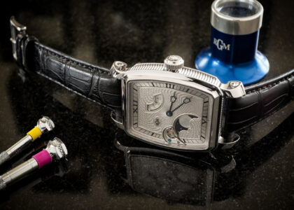 “Man wearing a Caliber 20 watch with a navy blazer and dark jeans”