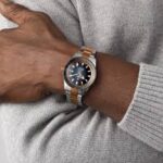 Rado Captain Cook R32137203 Automatic Men Watch worn by a man in a classic outfit, showcasing stainless steel case and ceramic bezel.