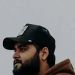 A man wearing the Street Chic Cap styled with a streetwear outfit, showcasing urban fashion in Lahore