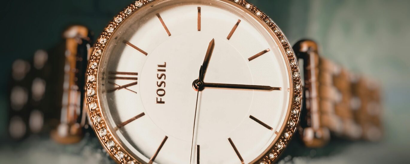 Elegant US brand watches for ladies displayed on a marble table with gold and rose gold finishes, styled with delicate jewelry.