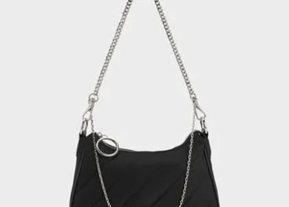 Ajmal Aristocrat Perfume for Women next to Charles & Keith Puffy Chain Bag in noir color, styled on a chic vanity.
