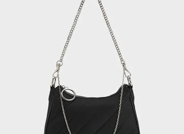 Ajmal Aristocrat Perfume for Women next to Charles & Keith Puffy Chain Bag in noir color, styled on a chic vanity.
