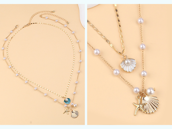 Flat lay of sea-inspired jewelry featuring shell earrings, a pearl necklace, and gold starfish charms styled on a beach towel with sunlight.