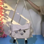 "Flat lay of trendy nylon bags styled with sunglasses and a phone, showcasing the popular nylon bag trend among Gen Z fashion lovers."