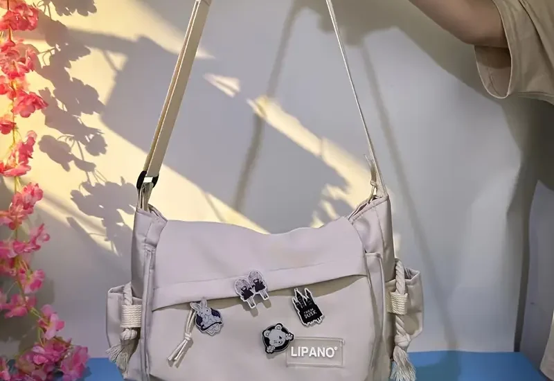 "Flat lay of trendy nylon bags styled with sunglasses and a phone, showcasing the popular nylon bag trend among Gen Z fashion lovers."