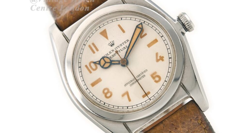 Vintage Rolex Oyster watch on leather strap styled with minimalist accessories for 2025 old-money aesthetic.