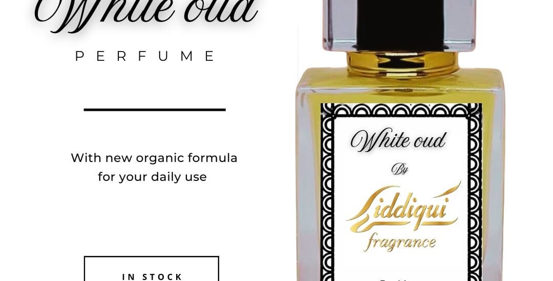 A minimalist perfume bottle of white oud fragrance placed on a marble tray with dried florals and soft lighting.