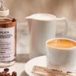Flat lay of edible-inspired perfume ingredients including caramel, vanilla, and cinnamon with a gourmand fragrance bottle.