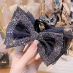 Rhinestone Bow Hair Clip styled on long wavy hair with pink coquette outfit