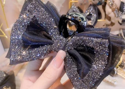 Rhinestone Bow Hair Clip styled on long wavy hair with pink coquette outfit