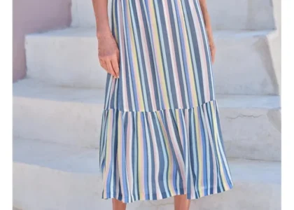 Flat lay of ballet flats, pastel cardigans, and ribbon hair ties – wear your tutu vibes summer fashion